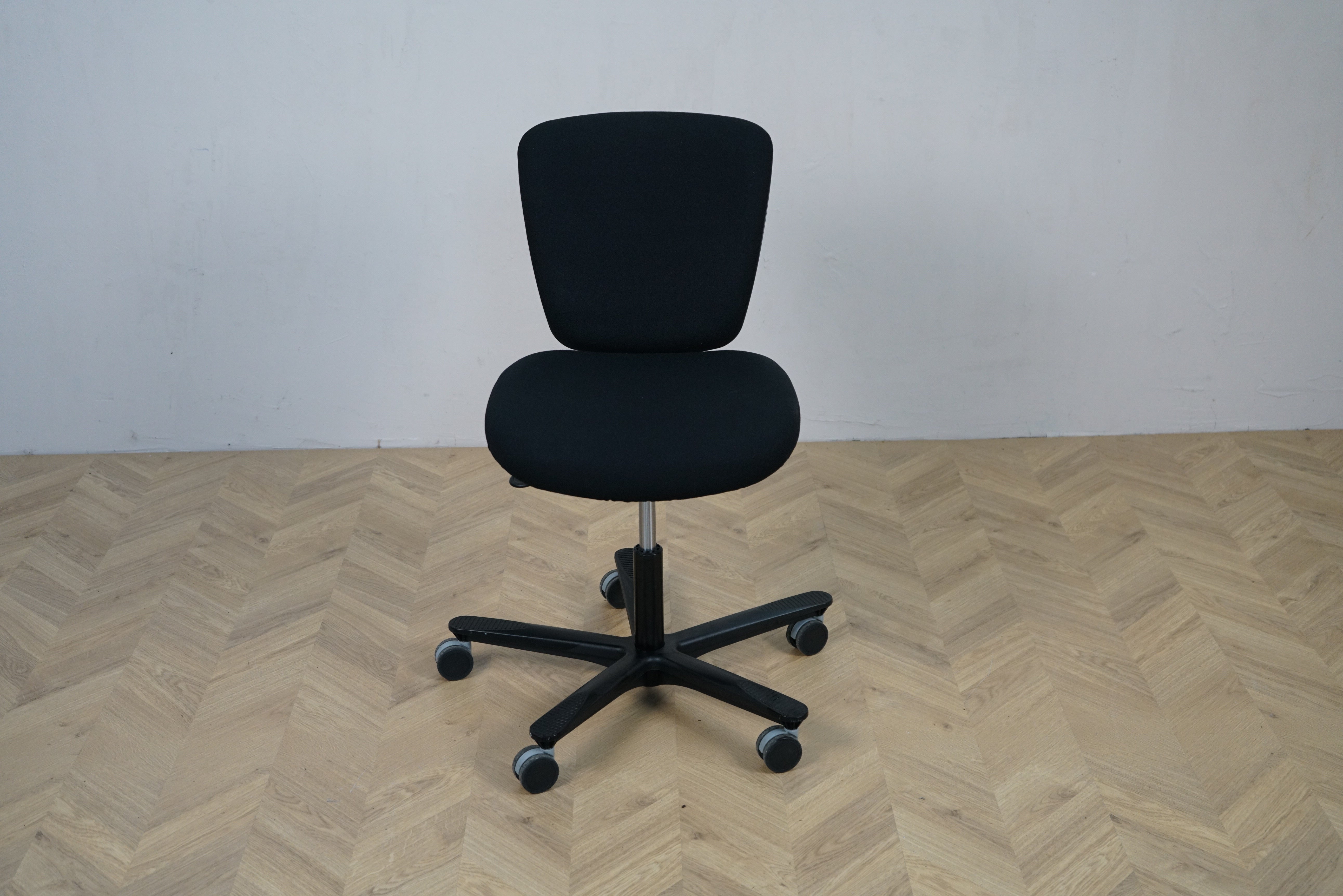 EFG sort kontorstol med lav ryg, sort fodkryds og ergonomisk design, set forfra.